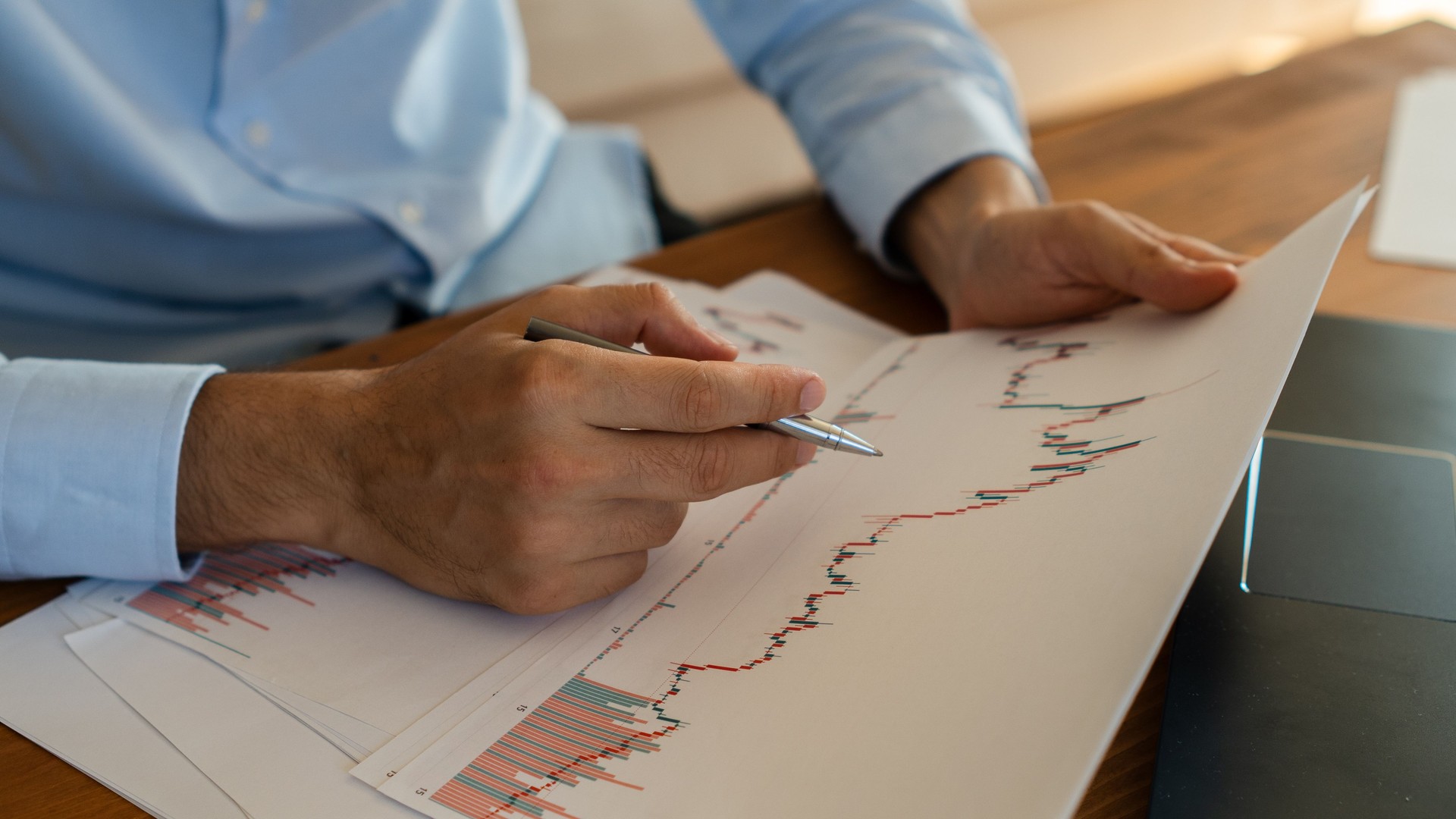 Businessman analyzing financial charts and graphs at workplace